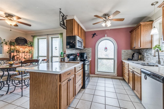 kitchen with appliances with stainless steel finishes, sink, backsplash, and decorative light fixtures