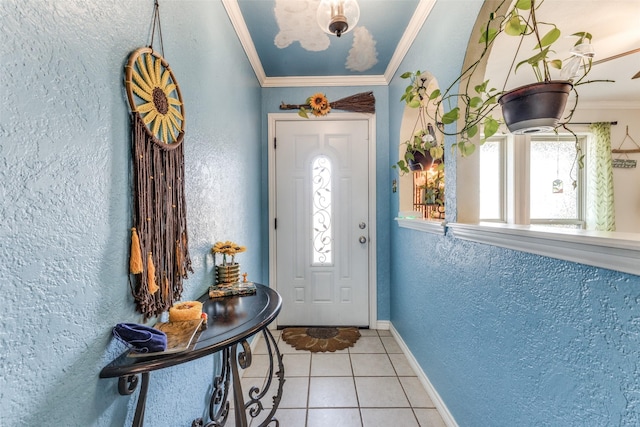 entrance foyer featuring light tile patterned floors and ornamental molding