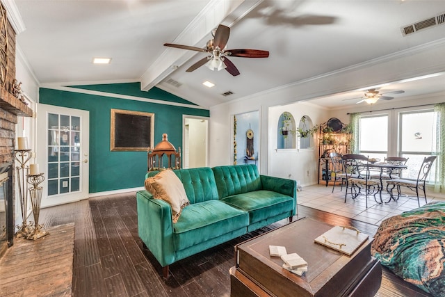 living room featuring a fireplace, wood-type flooring, ornamental molding, and vaulted ceiling with beams