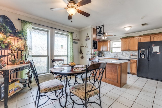 kitchen with dishwasher, backsplash, black fridge with ice dispenser, light tile patterned floors, and crown molding