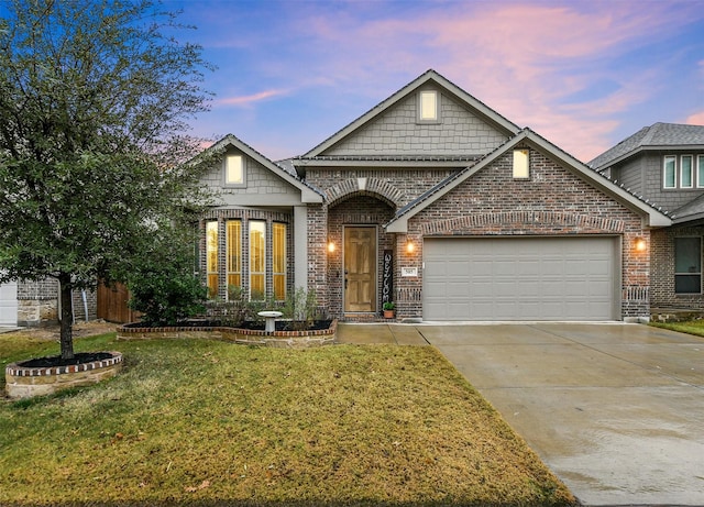 view of front of house with a garage and a lawn