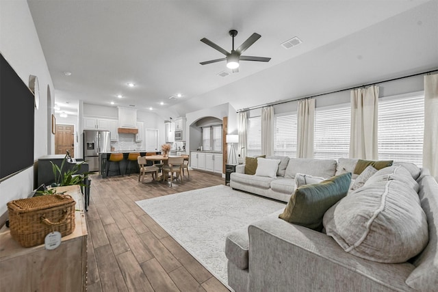 living room featuring hardwood / wood-style floors, a healthy amount of sunlight, and ceiling fan