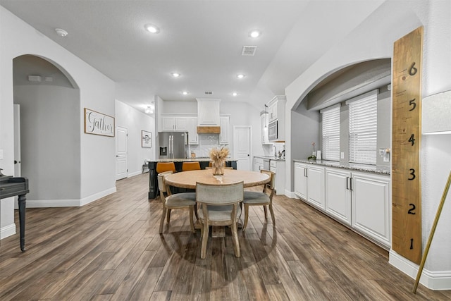 dining area with dark hardwood / wood-style floors