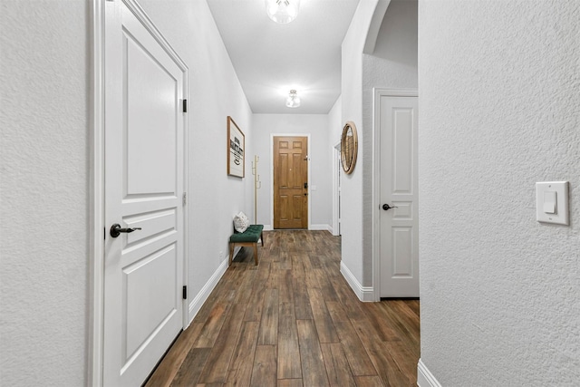 corridor with dark hardwood / wood-style floors