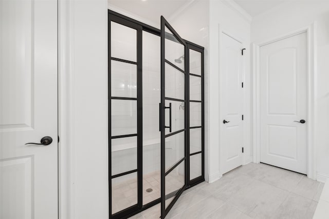 hallway featuring light tile patterned flooring and crown molding