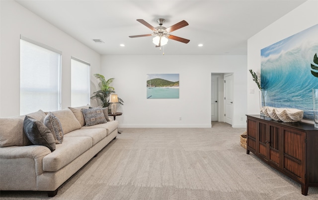 living area with light carpet, baseboards, visible vents, and recessed lighting