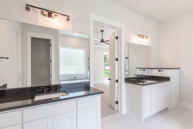 bathroom featuring marble finish floor, two vanities, and a sink