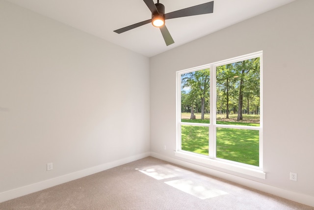 unfurnished room with baseboards, ceiling fan, carpet, and a healthy amount of sunlight