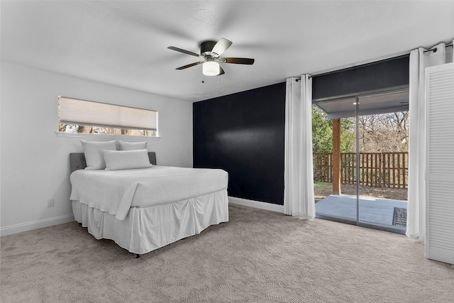 bedroom featuring light carpet, multiple windows, ceiling fan, and access to outside