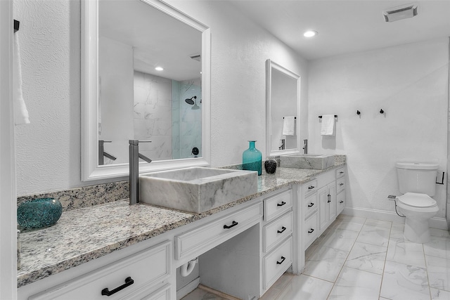 bathroom featuring a marble finish shower, visible vents, toilet, marble finish floor, and vanity