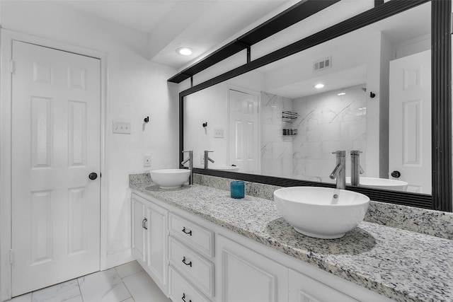 bathroom featuring vanity and a tile shower