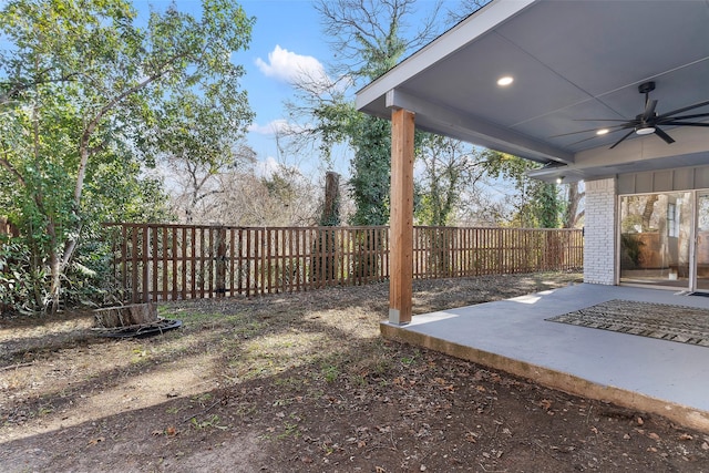 view of yard featuring a ceiling fan, a fenced backyard, and a patio