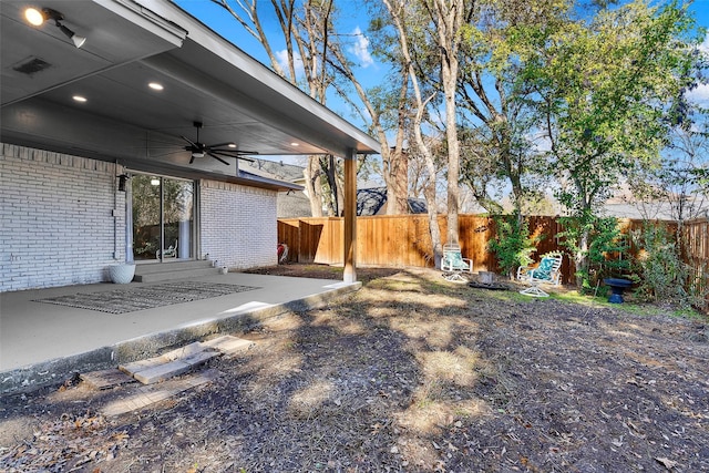 view of yard with ceiling fan, a patio, entry steps, fence private yard, and visible vents