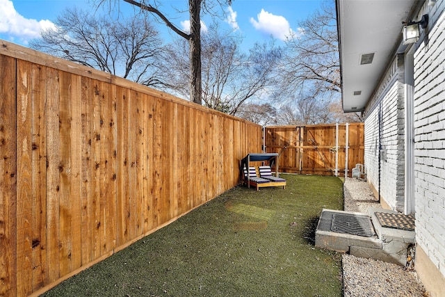 view of yard with a fenced backyard