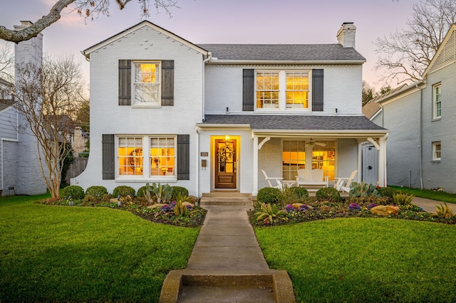 view of front of property with a lawn and covered porch