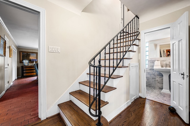 stairs featuring a fireplace and hardwood / wood-style floors