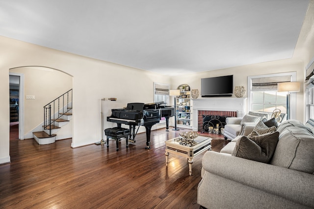 living room with dark hardwood / wood-style flooring and a fireplace