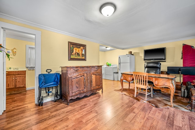 home office with separate washer and dryer, crown molding, and light hardwood / wood-style floors