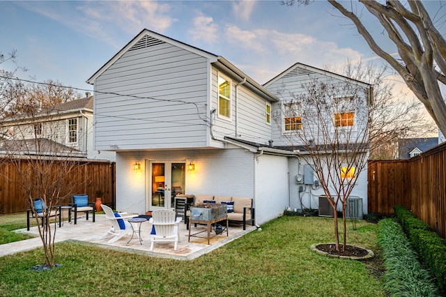 rear view of property with central AC, a yard, and a patio