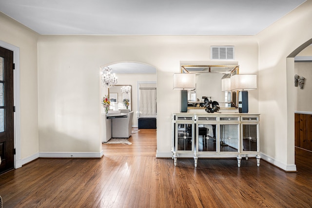 interior space with hardwood / wood-style flooring and a notable chandelier