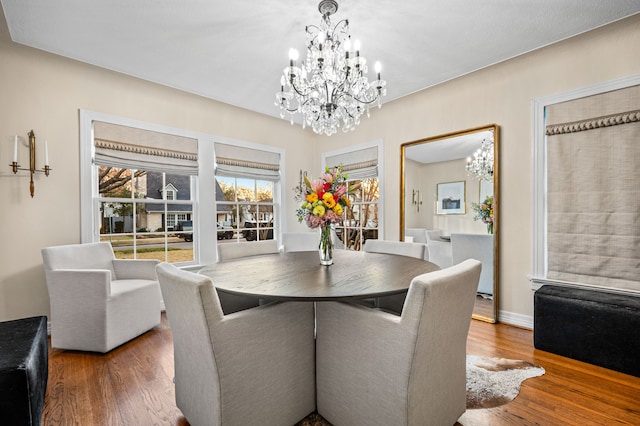 dining room featuring an inviting chandelier and hardwood / wood-style flooring