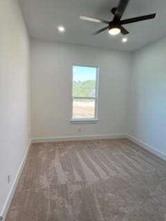 spare room with ceiling fan and carpet floors