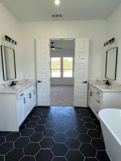 bathroom with a tub, tile walls, and vanity