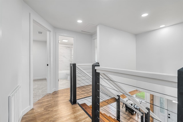 hallway with hardwood / wood-style flooring