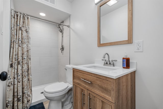 bathroom with vanity, curtained shower, and toilet