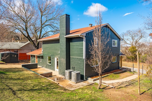 view of home's exterior with cooling unit, a yard, and a patio