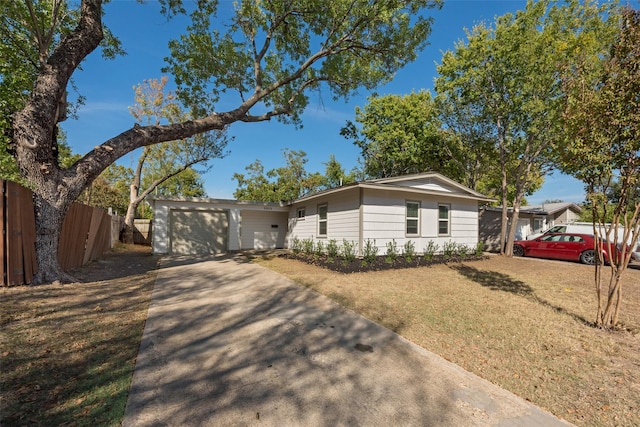 ranch-style house featuring a garage and a front lawn