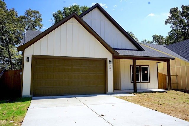 view of front of house with a garage, a front lawn, and a porch