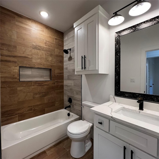 full bathroom with toilet, vanity, and tiled shower / bath