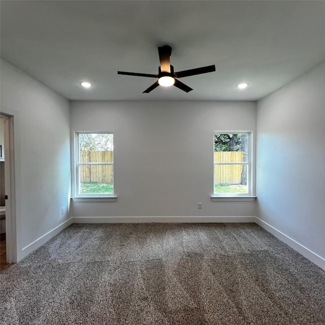 spare room with ceiling fan, carpet, and a healthy amount of sunlight