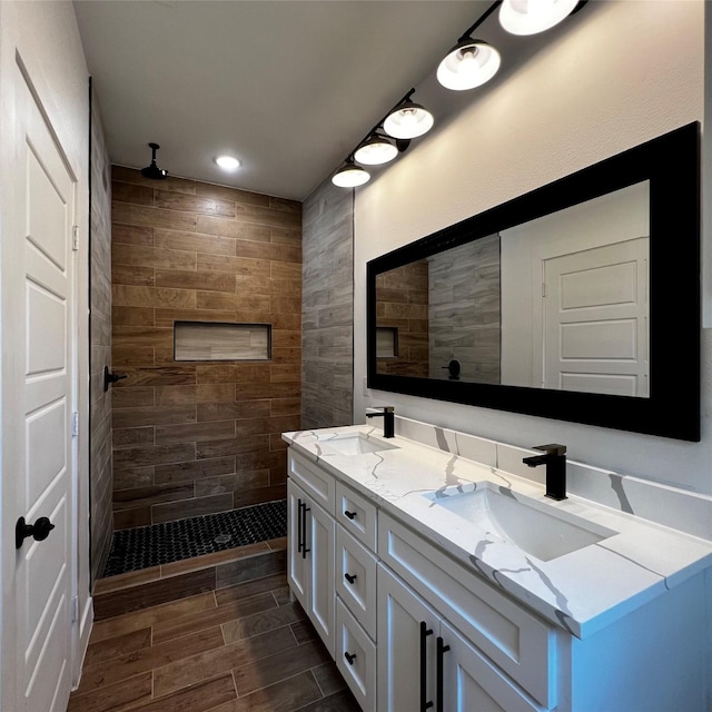 bathroom with vanity and a tile shower