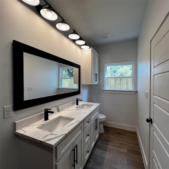 bathroom featuring toilet and vanity