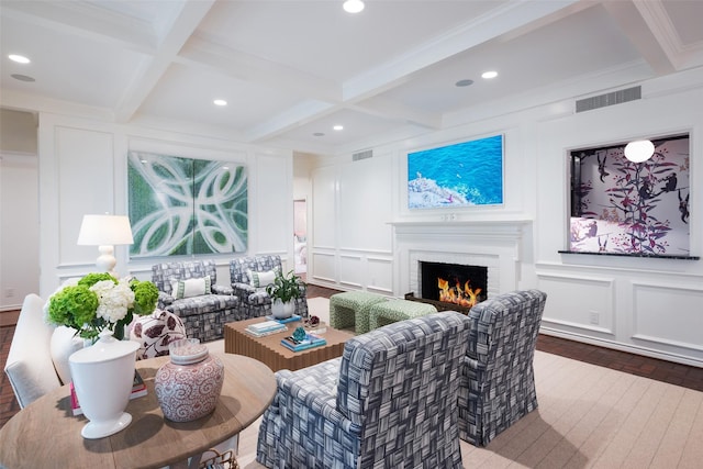 living room with wood-type flooring, crown molding, beam ceiling, and coffered ceiling