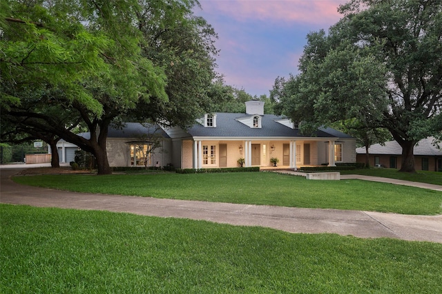 view of front of house featuring a lawn and a porch