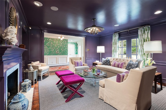 living room featuring a wealth of natural light, a chandelier, ornamental molding, and french doors