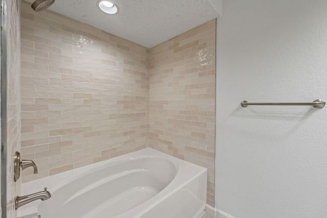 bathroom featuring shower / washtub combination and a textured ceiling