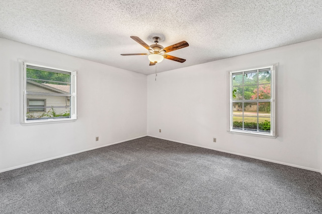 spare room with plenty of natural light, carpet floors, a textured ceiling, and ceiling fan