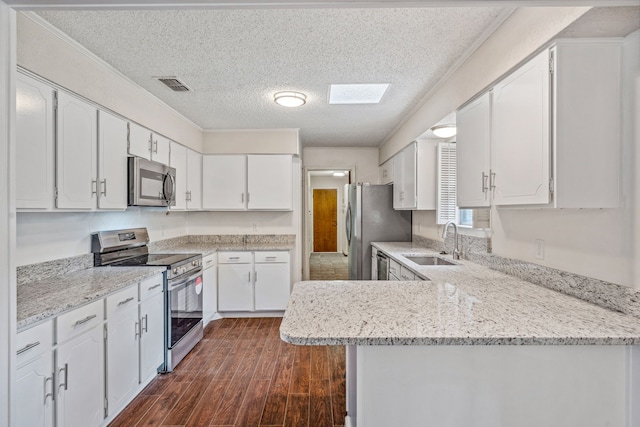 kitchen featuring appliances with stainless steel finishes and white cabinets