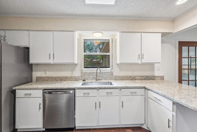 kitchen featuring white cabinetry, appliances with stainless steel finishes, sink, and a textured ceiling