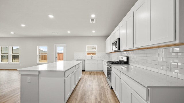 740 Vineyard Way, Forney, TX 75126 - kitchen featuring plenty of natural light, stainless steel appliances, a center island, and white cabinets