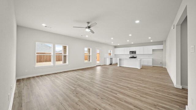 740 Vineyard Way, Forney, TX 75126 - unfurnished living room with light hardwood / wood-style floors and ceiling fan