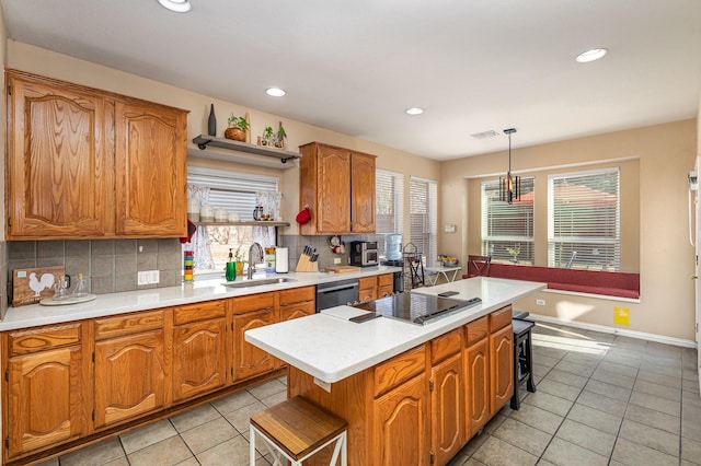 kitchen featuring black electric stovetop, backsplash, a kitchen island, pendant lighting, and sink