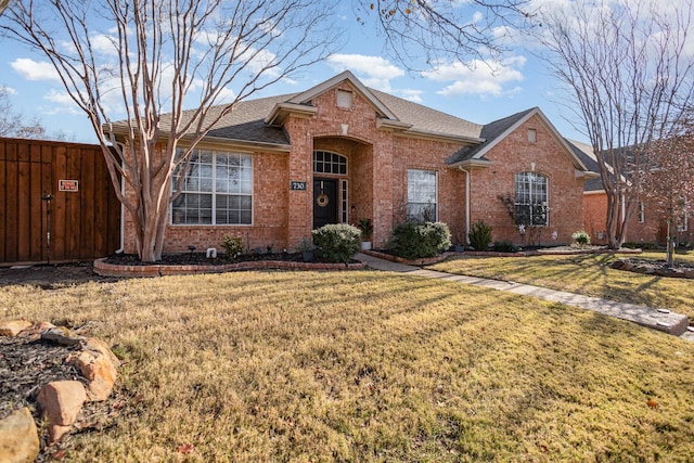 single story home featuring a front lawn