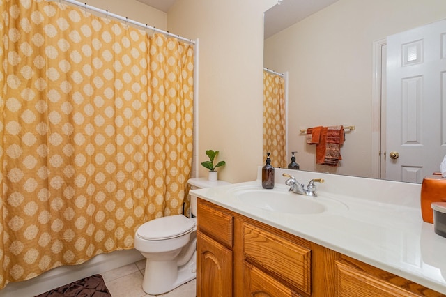 bathroom with toilet, tile patterned floors, and vanity