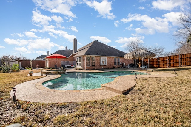 view of swimming pool featuring a patio area, an in ground hot tub, and a lawn