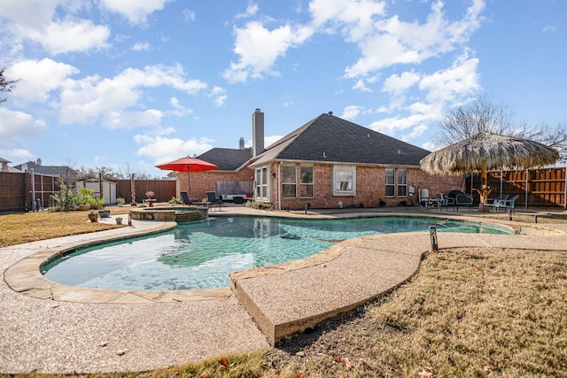 view of swimming pool featuring an in ground hot tub and a patio